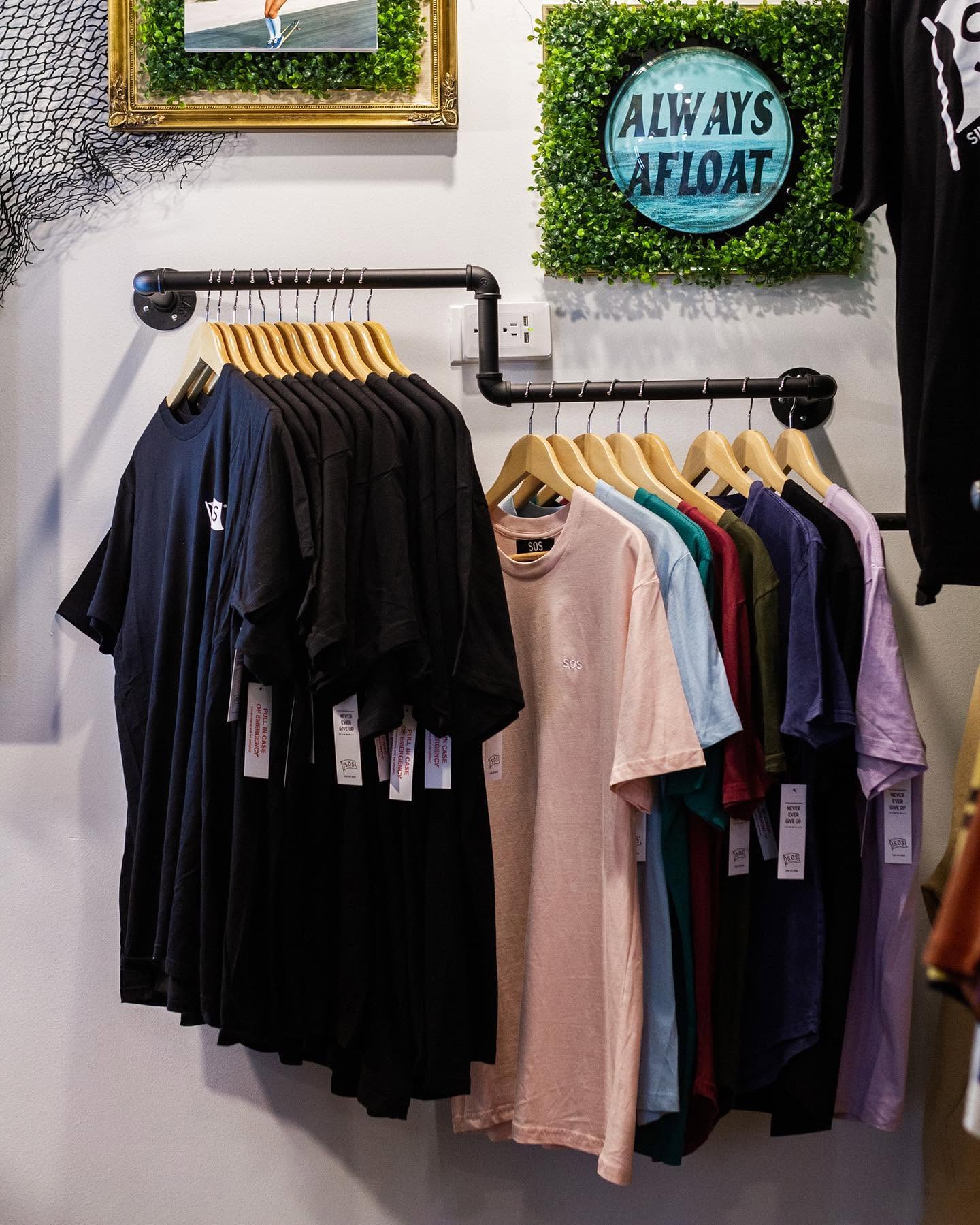 Colorful SOS shirts displayed in the retail store