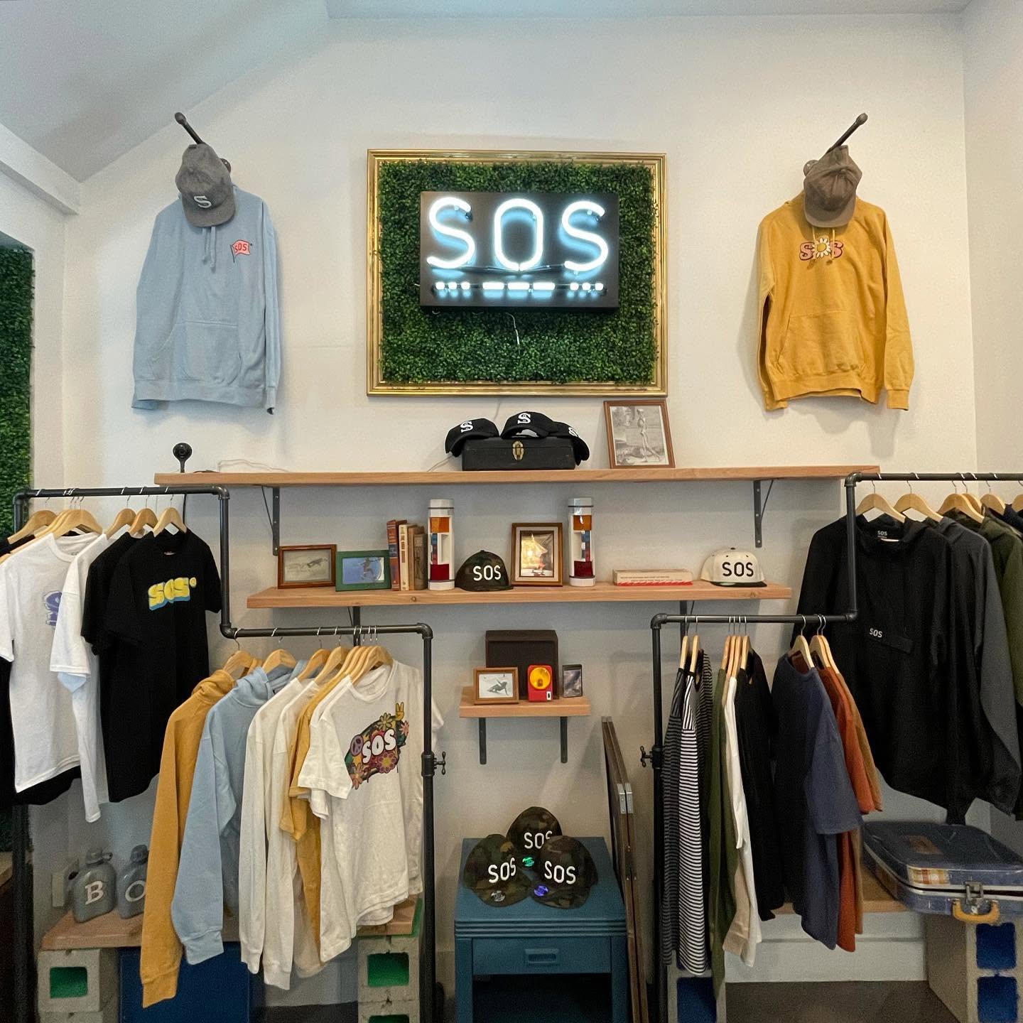 SOS retail wall with apparel and illuminated logo